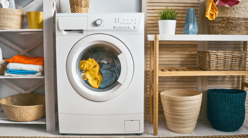 Interior of a real laundry room with a washing machine at home.