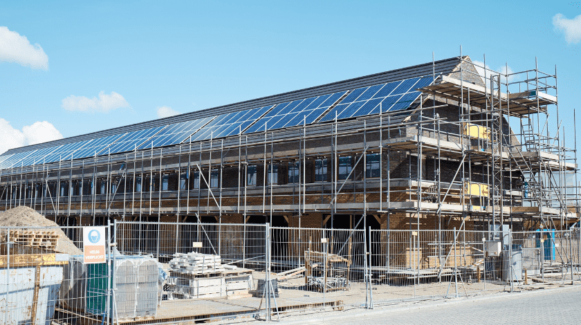House construction site of houses with solar panels.