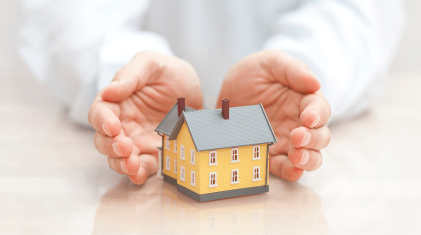 Small yellow house covered by hands